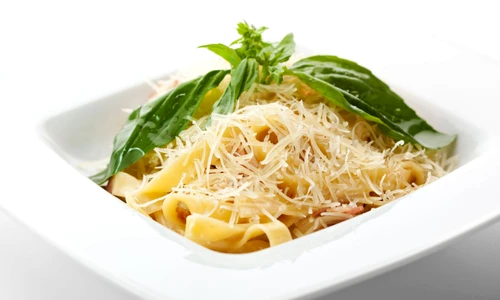 15172841   traditional fettucine alla carbonara with basil leaf jpeg