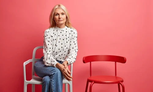 woman looks poses well dressed comfortable chair being alone waits queue isolated vivid pink jpg