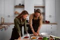 medium shot couple cooking together jpg