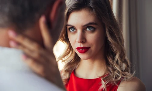 serious woman flirting hug her man while posing near window jpg