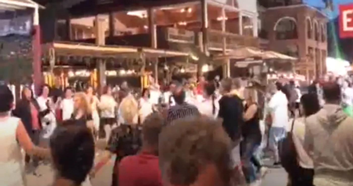 În fața unei terase,  oamenii au încins o horă