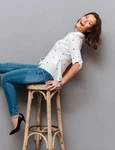 laughing woman posing chair looking camera gray jpg
