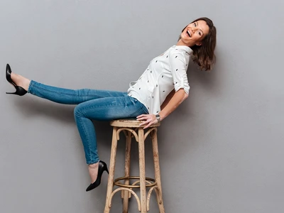 laughing woman posing chair looking camera gray jpg