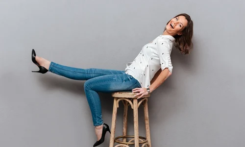 laughing woman posing chair looking camera gray jpg