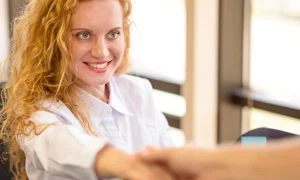 businesswoman holding hands smiles jpg