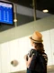 woman front airport flight information panel jpg