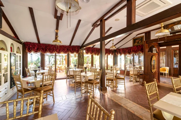 Restaurant relaxat cu mese și scaune de lemn.