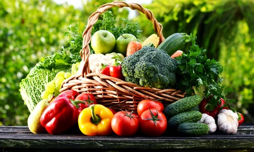 Wicker basket with assorted raw organic vegetables in the garden jpeg