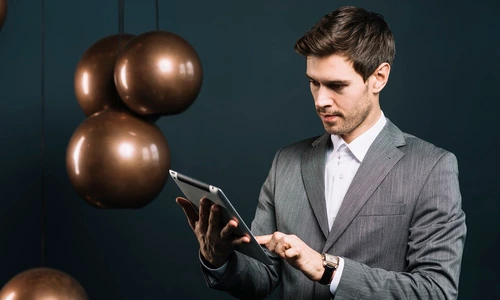 attractive young man using digital tablet with modern metal pendant jpg