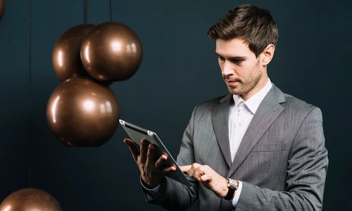 attractive young man using digital tablet with modern metal pendant jpg