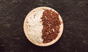 wooden bowl with raw red long grain jasmine white rice rough background jpg