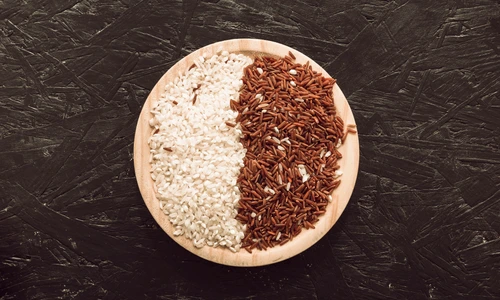 wooden bowl with raw red long grain jasmine white rice rough background jpg