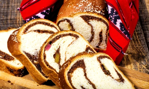 Slices of Romanian sponge cake with red traditional towel jpeg