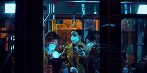 People Inside A Bus Wearing Masks
