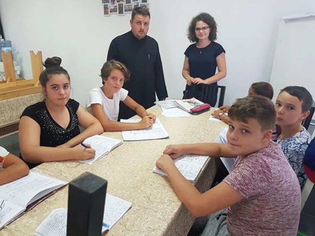 Preotul Florin Danu, alături de câţiva dintre copiii care participă la orele de engleză FOTO Florin Danu