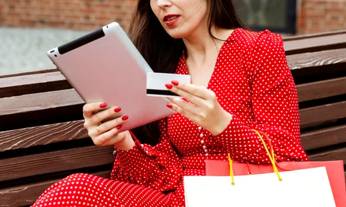 side view woman with laptop credit card purchasing online jpg