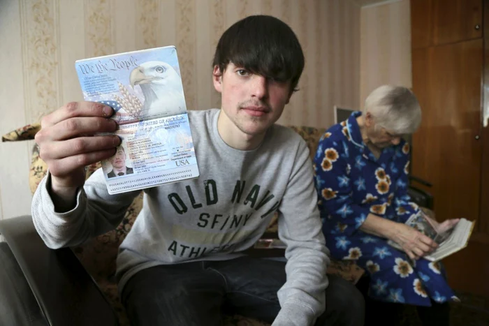 Tânărul arată jurnaliştilor ruşi paşaportul american. FOTO: AP
