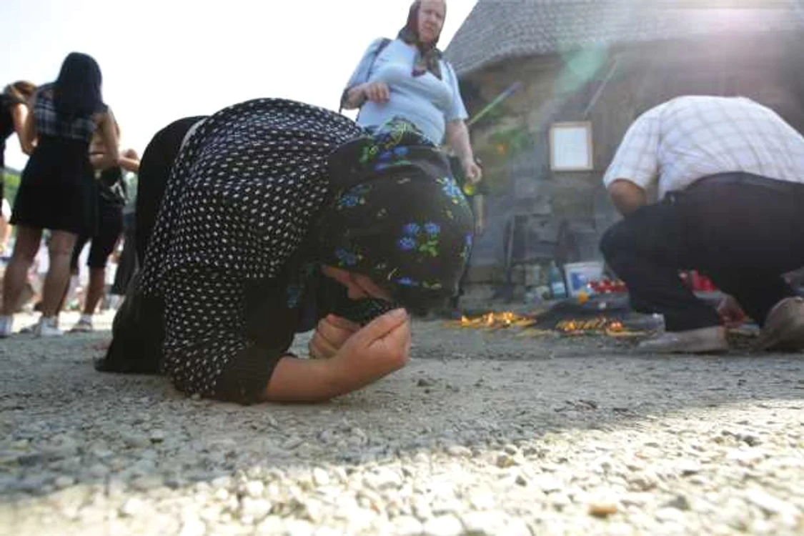 Femeie rugându-se în genunchi FOTO Adevărul