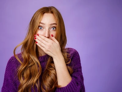 impressed speechless cute ginger girl hearing stunning gossip covering mouth form amazement shoo jpg