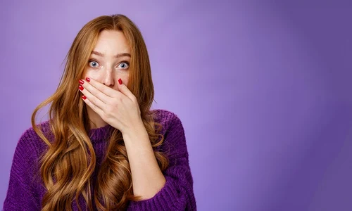 impressed speechless cute ginger girl hearing stunning gossip covering mouth form amazement shoo jpg