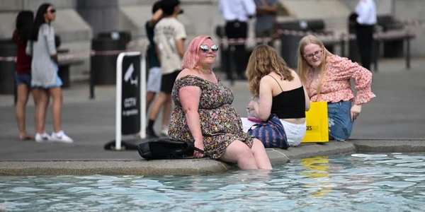 Canicula in Marea Britanie - Femei se răcoresc într-o fântână arteziană din Londra FOTO Profimedia