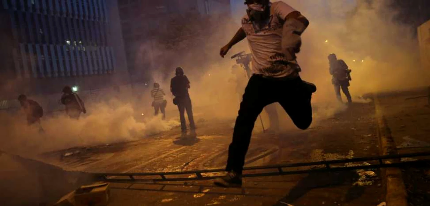 Proteste la Caracas împotriva guvernului care nu ia măsuri eficiente pentru a combate infracţiunile, în februarie 2014/FOTO Getty Images/Business Insider