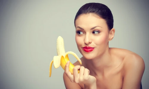 pretty woman looking at banana jpeg