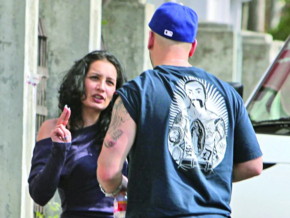 Se pare că bruneta încearcă să-i explice ceva cântăreţului, gesticulând...