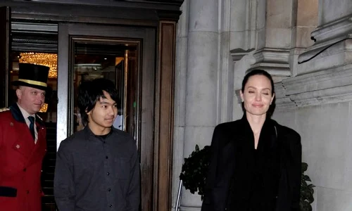 Angelina Jolie stares adoringly at her son Maddox as they head to Buckingham Palace jpeg