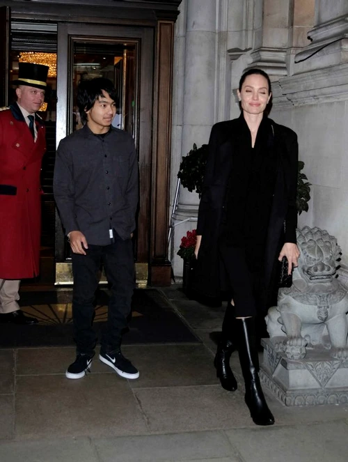 Angelina Jolie stares adoringly at her son Maddox as they head to Buckingham Palace jpeg