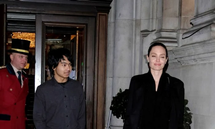 Angelina Jolie stares adoringly at her son Maddox as they head to Buckingham Palace jpeg