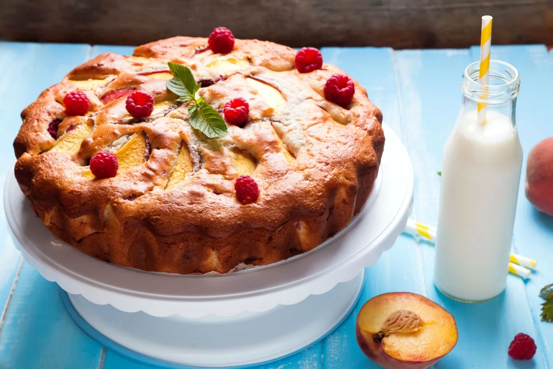 30391762 delicious pie with peaches and raspberry on the blue background jpeg