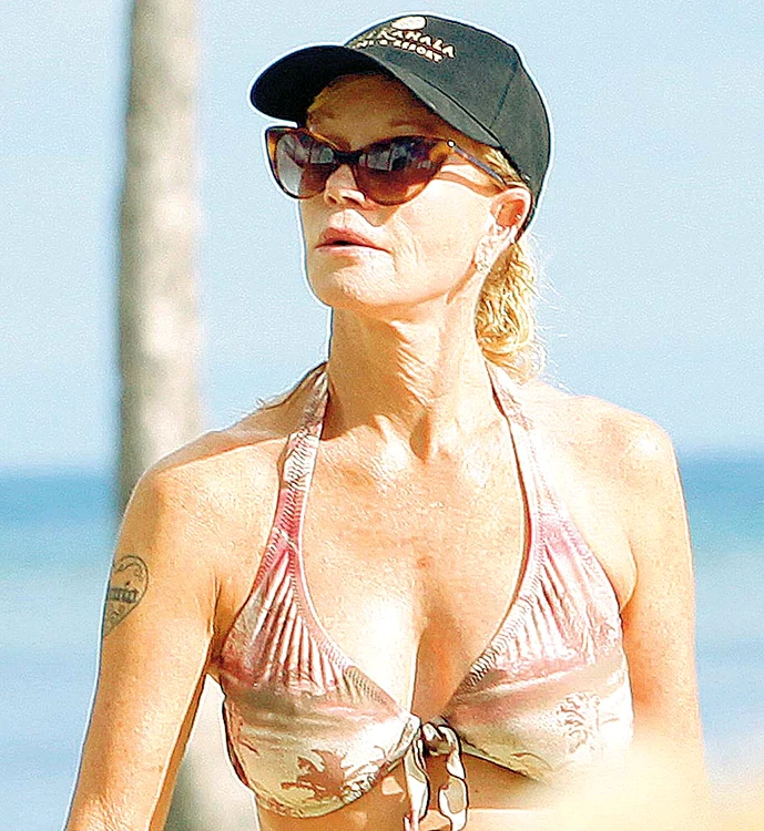 
    Cât timp a stat la plajă, Melanie  Griffith nu a folosit loţiuni de corp,  în schimb a fumat ca o turcoaică  