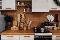 close up modern cozy kitchen white brown colors with stuff cooker decorative fir tree branches christmas decorations jpg