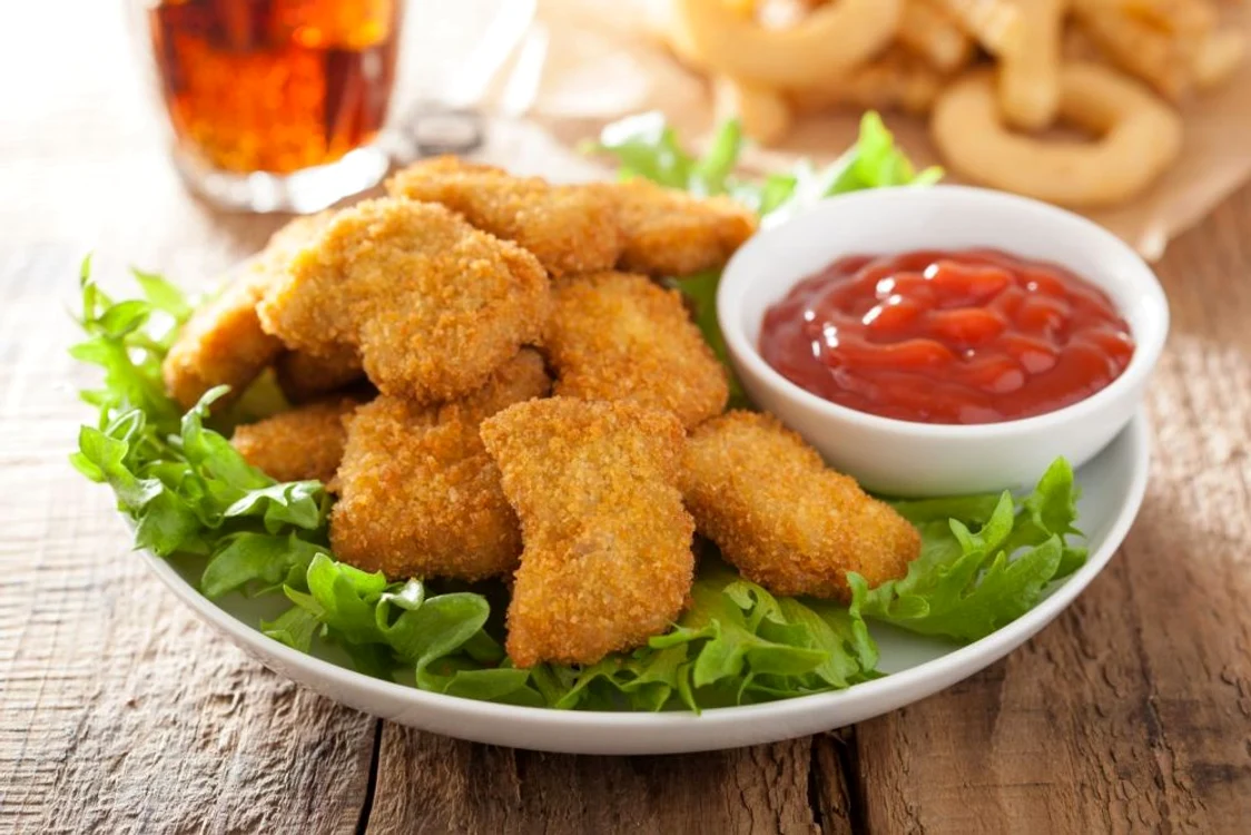 41631904   fast food chicken nuggets with ketchup, french fries, cola jpeg