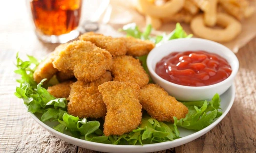 41631904   fast food chicken nuggets with ketchup, french fries, cola jpeg