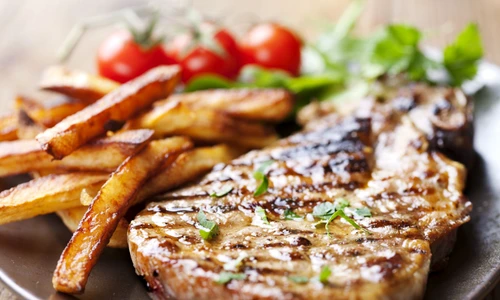 12614754   juicy grilled pork chop  neck cut  with greens jpeg