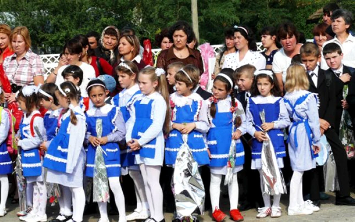 Prima zi de școală în comunism: cântece patriotice, dedicate conducătorului suprem, cravatele tricolore, uniformele apretate, șosete și bentițe albe
