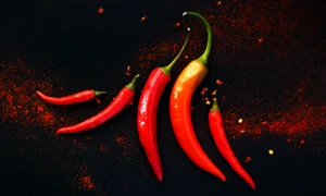 46018788   chili peppers on a black background jpeg