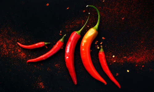 46018788   chili peppers on a black background jpeg
