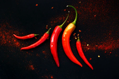 46018788   chili peppers on a black background jpeg