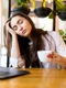 portrait tired young businesswoman sitting table with laptop computer while holding cup coffee sleeping cafe jpg