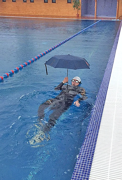 Chiar dacă a plouat,  Gabriel a înotat cu  o umbrelă în mână 