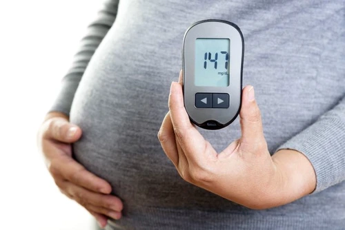 1 pregnant woman with glucometer 1 jpg jpeg