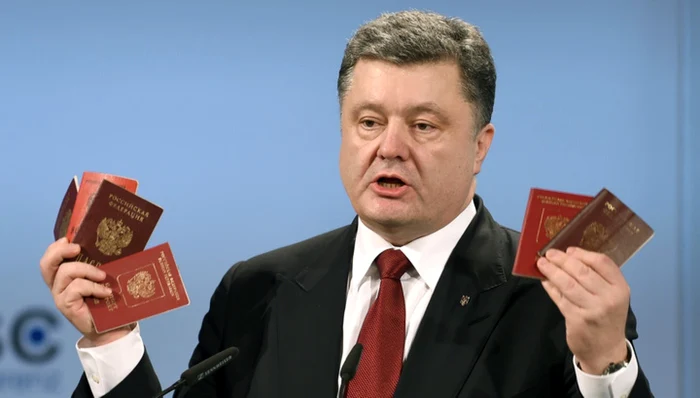 Preşedintele Ucrainei, Petro Poroşenko, le arată la Munchen jurnaliştilor paşapoartele sodaţilor ruşi reţinuţi în Donbas. FOTO: vesti.ru