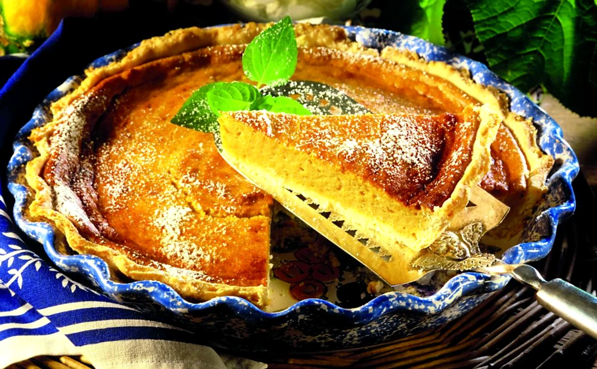 Pumpkin pie with icing sugar (a piece cut) jpeg