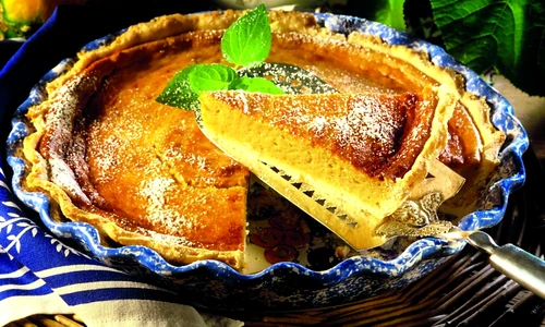 Pumpkin pie with icing sugar (a piece cut) jpeg