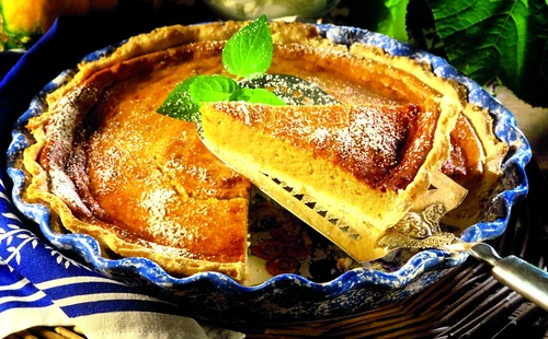 Pumpkin pie with icing sugar (a piece cut) jpeg