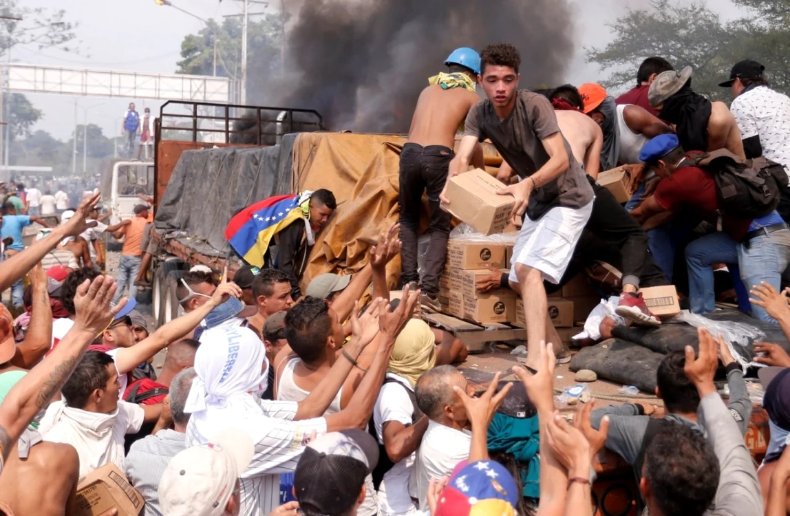 Zeci de oameni vor să primească ajutoare umanitare încărcate 
într-un camion care a fost oprit în Ureña, Venezuela FOTO EPA – EFE / 
Deibison Torrado