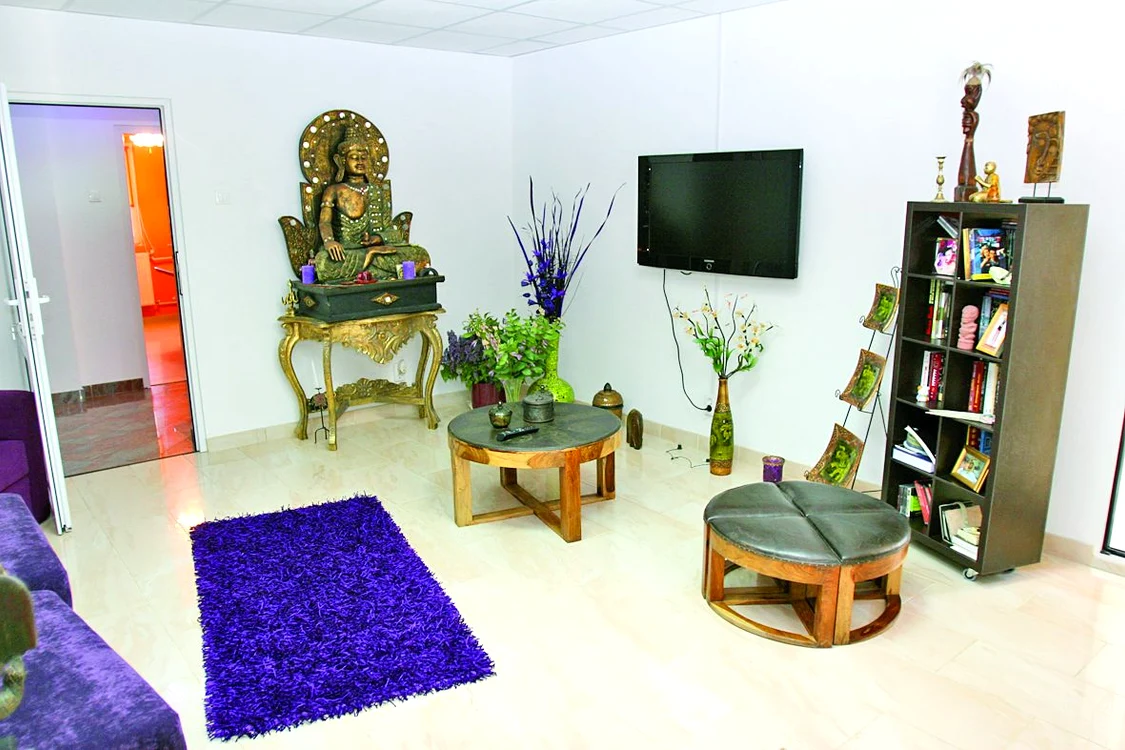 Buddha din living te duce cu gândul la Orient. Măsuţele sunt din lemn şi piele de vacă